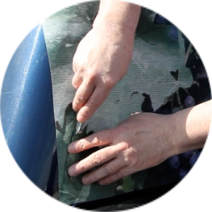 Trimming excess vinyl along the vehicle window seam with a utility knife